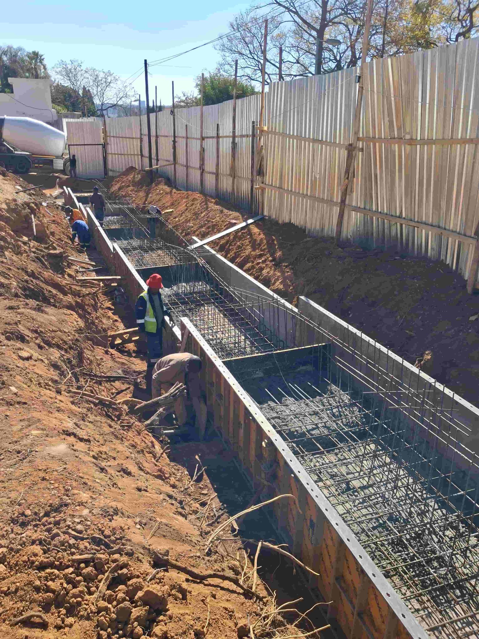 Construction workers laying concrete paving at Sandhurst Mansion residential property